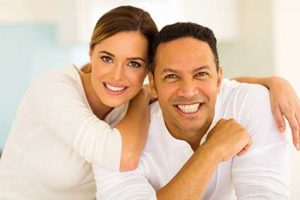 patient smiling with her husband after getting dental crowns at Radiant Family Dentistry