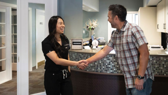 Scottsdale dentist Dr. Christine Chan shaking hands with a happy patient