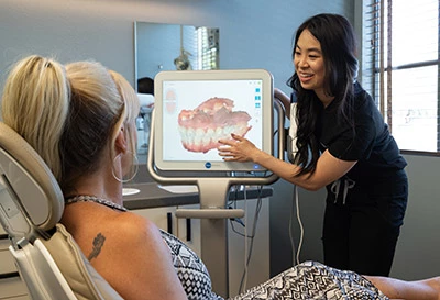 Dr. Chan showing a patient their iTero scanner images