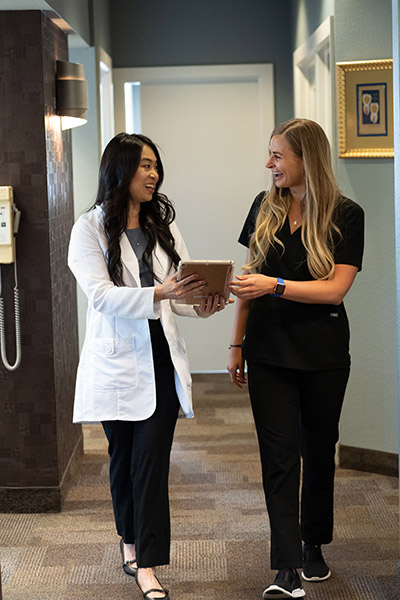 Our team at Radiant Family Dentistry discussing a patient's paperwork