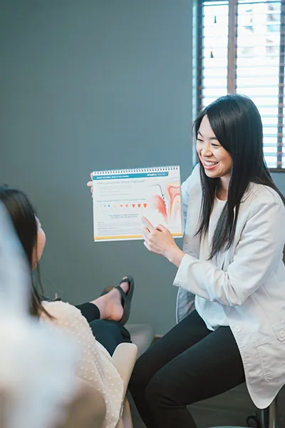 Dr. Chan discussing how dental implants work with a patient