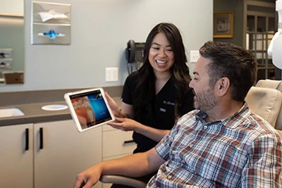 Dr. Chan showing patient a 3-D scan of their mouth