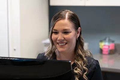 Samantha scheduling a patient's dental veneers appointment